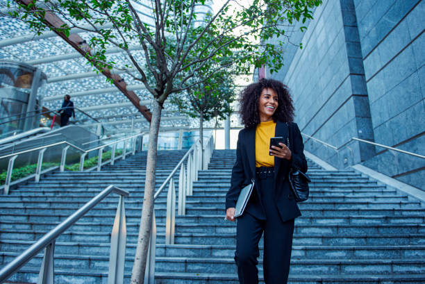 istock Cheerful businesswoman using her smart phone outside 2183509572