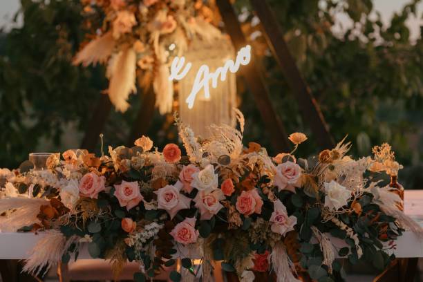 Wedding reception table with a neon sign reading 