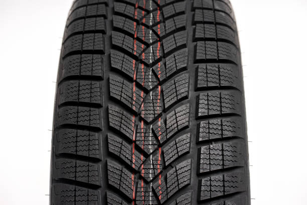 The tread of a wet all-season car tire. Car tire tread close-up.