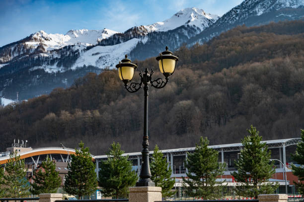A mountain range with a small town in the valley below. The town is surrounded by snow and the mountains are covered in snow. The scene is peaceful and serene