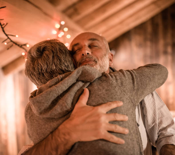 istock senior couple embracing at home for christmas 2183514757