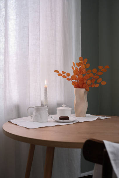 istock An Elegant Table Setting with a Candle and Floral Arrangement that radiates charm 2183516528