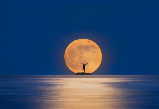 istock sea, composite image female figure on rock. 2183520303