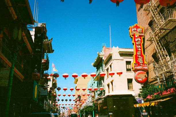 Low-angle view of old street and Chinese lanterns at Chinatown central district of San Francisco city, California. Shot on 35 mm camera film