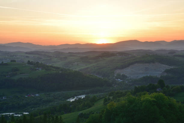 istock Panoramatic orange sunset over forests and meadows in the evening 2183522200