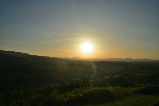 istock Panoramatic orange sunset over forests and meadows in the evening 2183522252