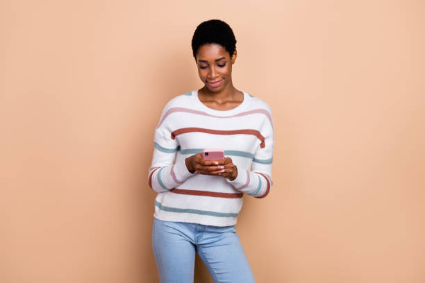 istock Photo of funny sweet human dressed pullover writing modern device isolated beige color background 2183522871