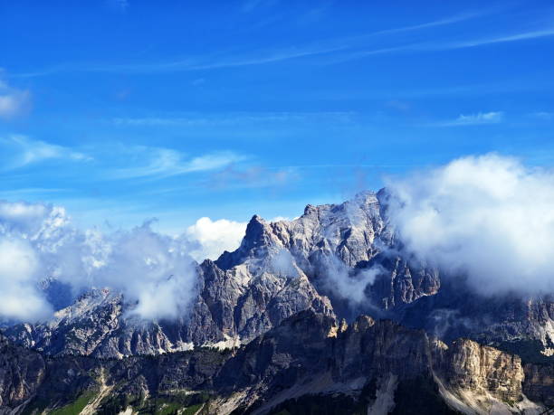 istock Majestic mountain range under a bright blue sky with fluffy clouds at the Dolomiti d'Ampezzo Nature Park 2183525059