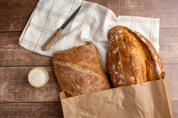 istock Freshly baked bread on wooden table with rolling pin. 2183526125