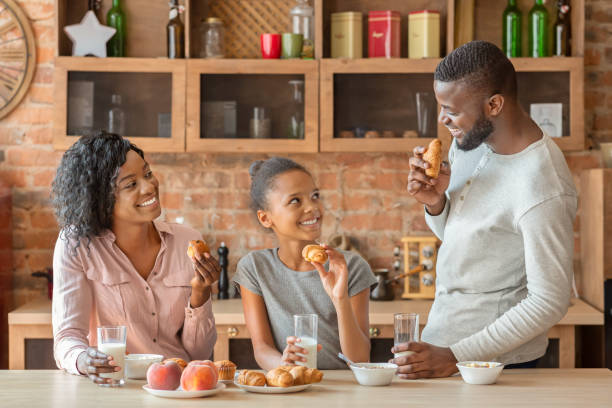 istock Friendly young family having conversation during breakfast at kitchen 2183526669