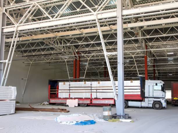 istock Truck loaded with building materials inside an industrial construction site warehouse. 2183528263
