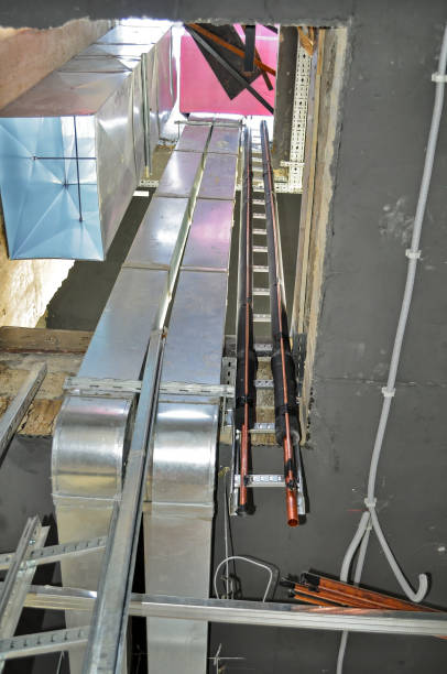 istock Electrical cable trays and ventilation ducts installed in a ceiling opening at a construction site. 2183528277