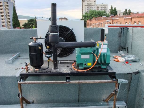 istock HVAC equipment installation on a restaurant rooftop, featuring a compressor and air conditioner. 2183528286