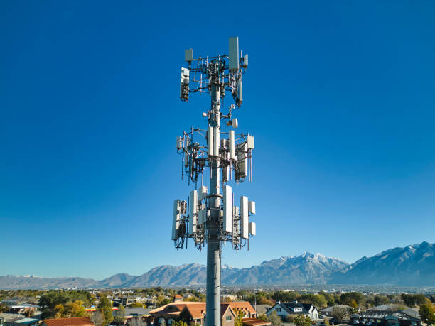 Comminication Tower Against a Blue Sky An aerial view of a communication tower against a blue winter sky. communications tower stock pictures, royalty-free photos & images