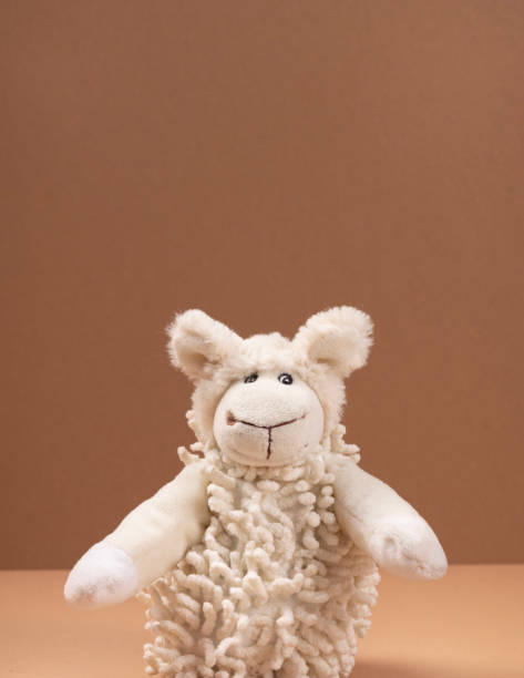istock Soft toy sheep on a beige background with space for your text 2183529239