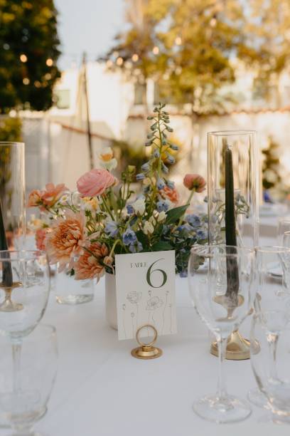 istock Table covered in a white tablecloth, set for a wedding reception with floral centerpiece 2183532065