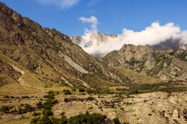 istock Caucasus, mountainous rocky view, blue sky with white cottony clouds 2183533179