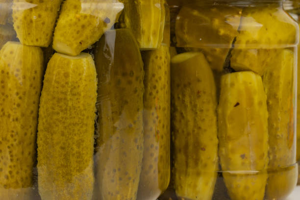istock pickled cucumbers with tomatoes in glass jars 2183533187