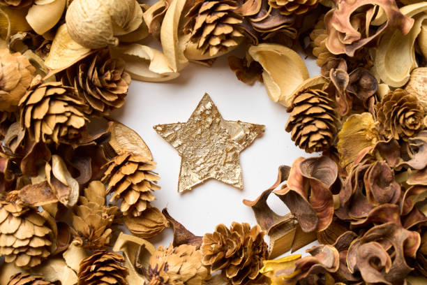 Star-shaped decoration amongst fallen leaves on the table