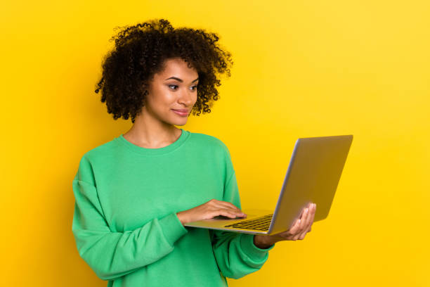 istock Photo of smart intelligent curly lady use wireless netbook write email isolated on yellow color background 2183537252