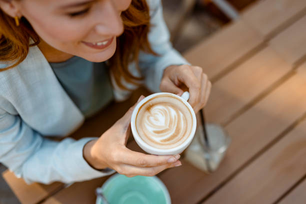 istock Close-up of latte with beautiful foam art held. 2183537400