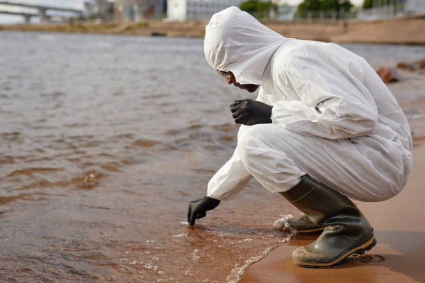 istock Scientist in Hazmat Gear Doing Tests on Water 2183538564