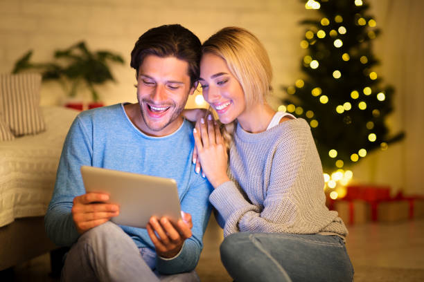 istock Romantic couple sharing digital tablet on winter evening 2183539982