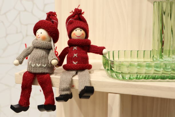 These two charming dolls wear cozy winter outfits, making them perfect for festive decoration and seasonal cheer