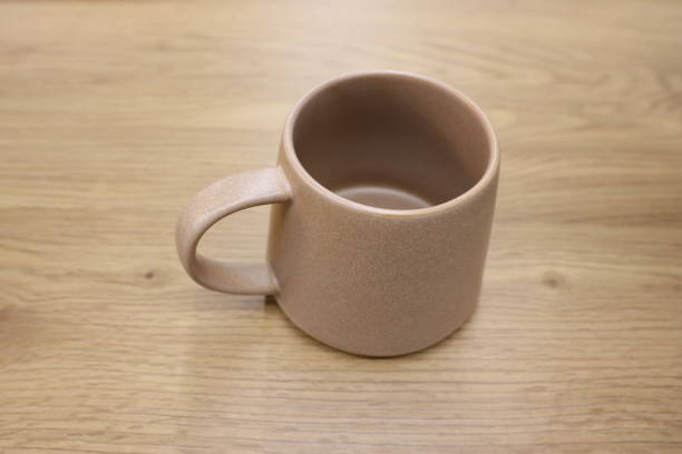 istock A Simple Yet Elegant Minimalist Beige Ceramic Mug Set Down on a Beautiful Wooden Table 2183544311