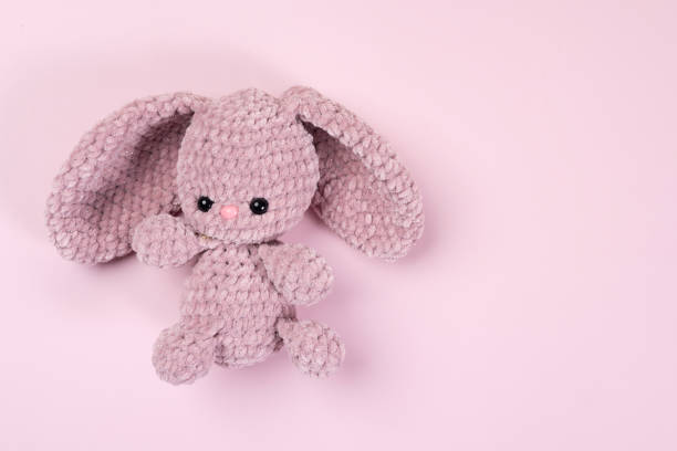 istock Handmade soft toy on a pink background 2183544561