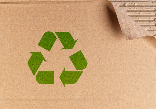 istock Green recycling symbol on brown cardboard packing box 2183546725
