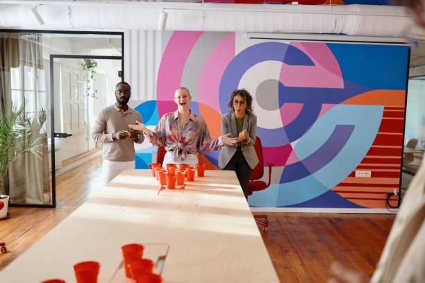 istock Smiling colleagues playing beer pong 2183548709