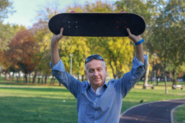 istock Mature man skateboarding in public park 2183549380