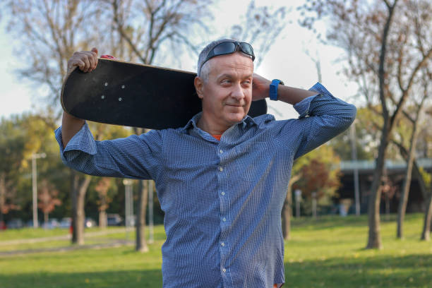 istock Mature man skateboarding in public park 2183549433