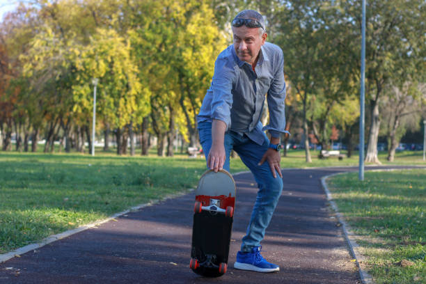 istock Mature man skateboarding in public park 2183549441
