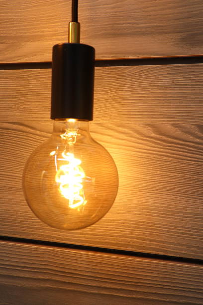 istock A Stylish Vintage Edison Light Bulb Elegantly Set Against an Appealing Wooden Background 2183550909