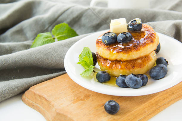 istock A healthy breakfast of cheese pancakes and honey. 2183551064