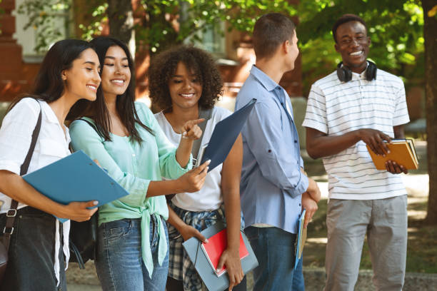 istock Cheerful Female College Students Checking Schedule Of Classes While Standing Outdoors 2183552357