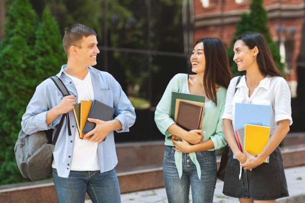 istock Handsome University Student Chatting With Two Female Classmates Outdoors 2183552877