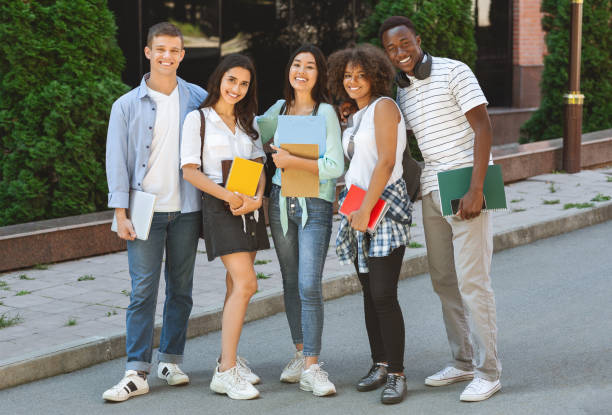 istock Multiethnic group of students standing outdoors in school campus with workbooks 2183552885