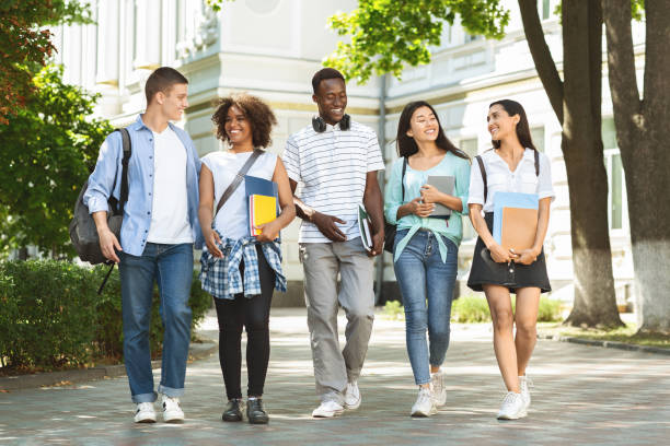 istock Students communication. Group of college friends walking outdoors in university campus 2183552921