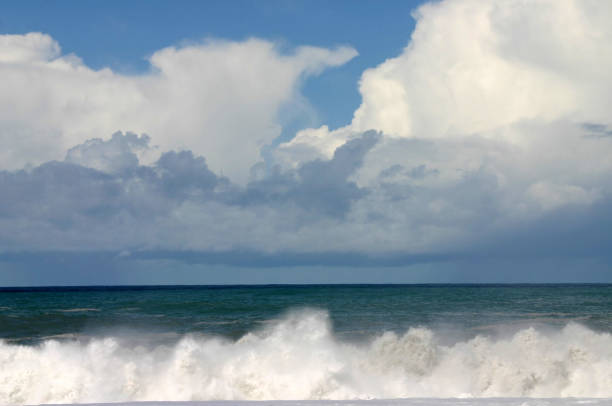 Springtime after storm.   Breaking waves, clouds, ocean and blue sky.  Good screen saver and background.