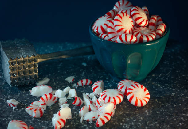 Peppermint candy is crushed with a vintage meat tenderizer mallet in preparation to make peppermint bark, Dec. 31, 2018, in Coden, Alabama.