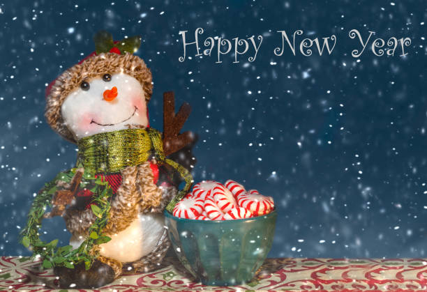 A stuffed snowman stands beside a bowl of peppermint candy, Dec. 31, 2018, in Coden, Alabama.