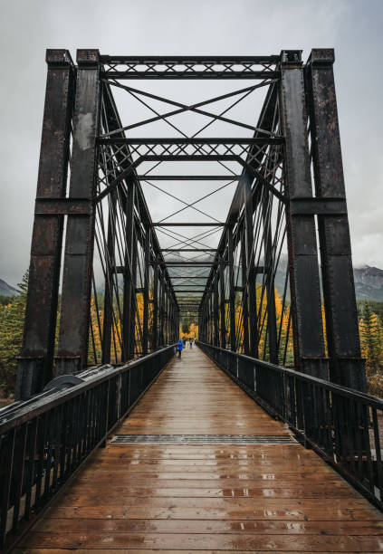 istock Metal bridge crossing river in Canmore, Alberta on rainy fall day. 2183557646