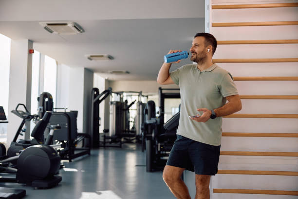 istock Happy athlete drinking water from a bottle in a gym. 2183558302