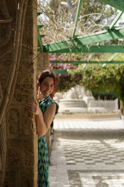 istock A smiling middle-aged woman peeks out behind a column 2183558846