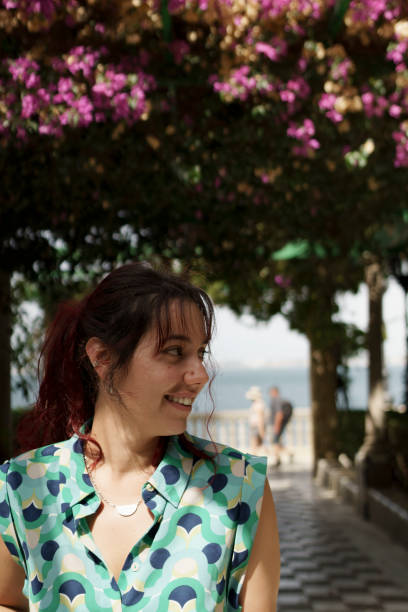 istock a smiling middle aged woman dressed in green looks lefts 2183558848