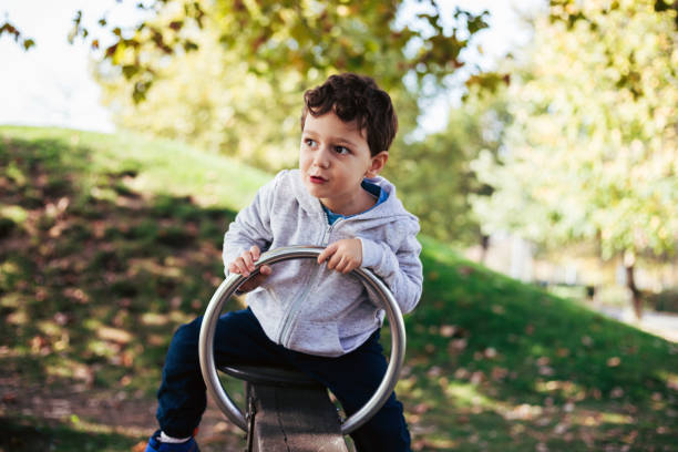 istock Young Boy Having Fun on the Seesaw at the Playground 2183560420