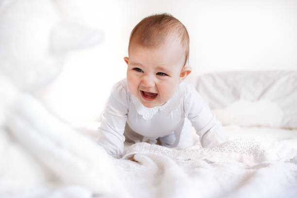 istock Cute Baby Crying and Crawling on Bed 2183562185